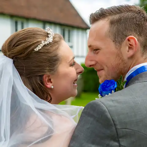 Wedding photo of the bride and groom closeup looking at each other at Brookmans Park Golf Club, Hatfield, Hertfordshire.  – photography by Glen Smith