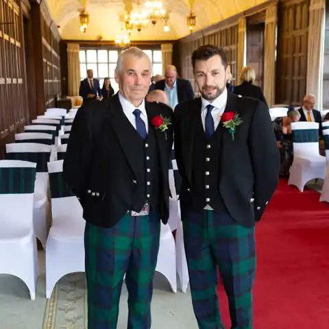 Wedding photo of the groom and best man waiting in the Long Gallery in Fanhams Hall, where the ceremony takes place at Fanhams Hall, Ware, Hertfordshire.  – photography by Glen Smith