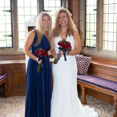 Wedding photo of the bride and bridesmaid at Fanhams Hall, Ware, Hertfordshire.  – photography by Glen Smith