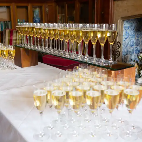 Wedding photo of spectacular arrangement of glasses of champagne at Fanhams Hall, Ware, Hertfordshire.  – photography by Glen Smith