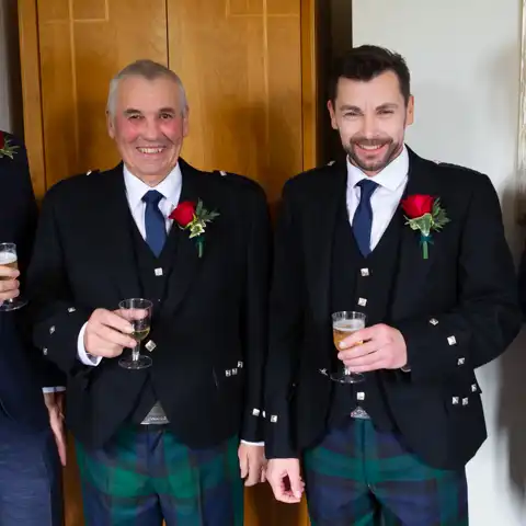Wedding photo of the groom and best man in Scottish tartan at Fanhams Hall, Ware, Hertfordshire.  – photography by Glen Smith